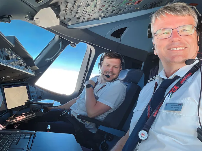 A photo of my father and I in the flight deck of an Airbus A350.